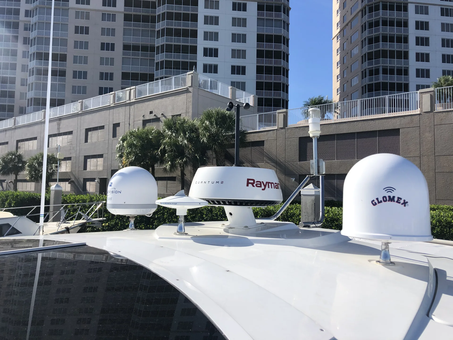 Marine radar and satellite antenna equipment mounted above a vessel.