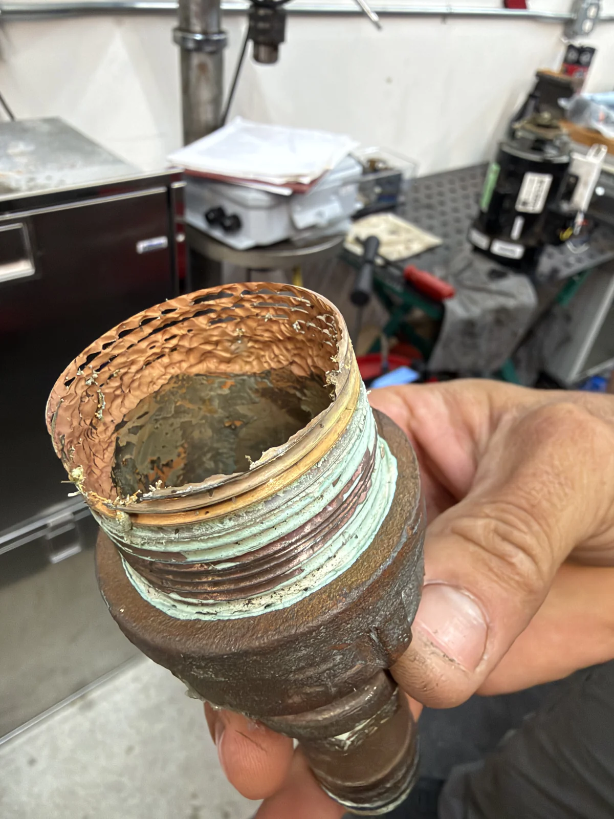Very heavy corrosion and material loss on a bronze threaded coupling. The served system and vessel are not assigned.