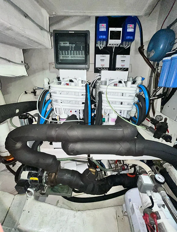 Dual Dometic chiller installation with controls and insulated piping among adjacent equipment, identified by ACCUMAR’s owner.