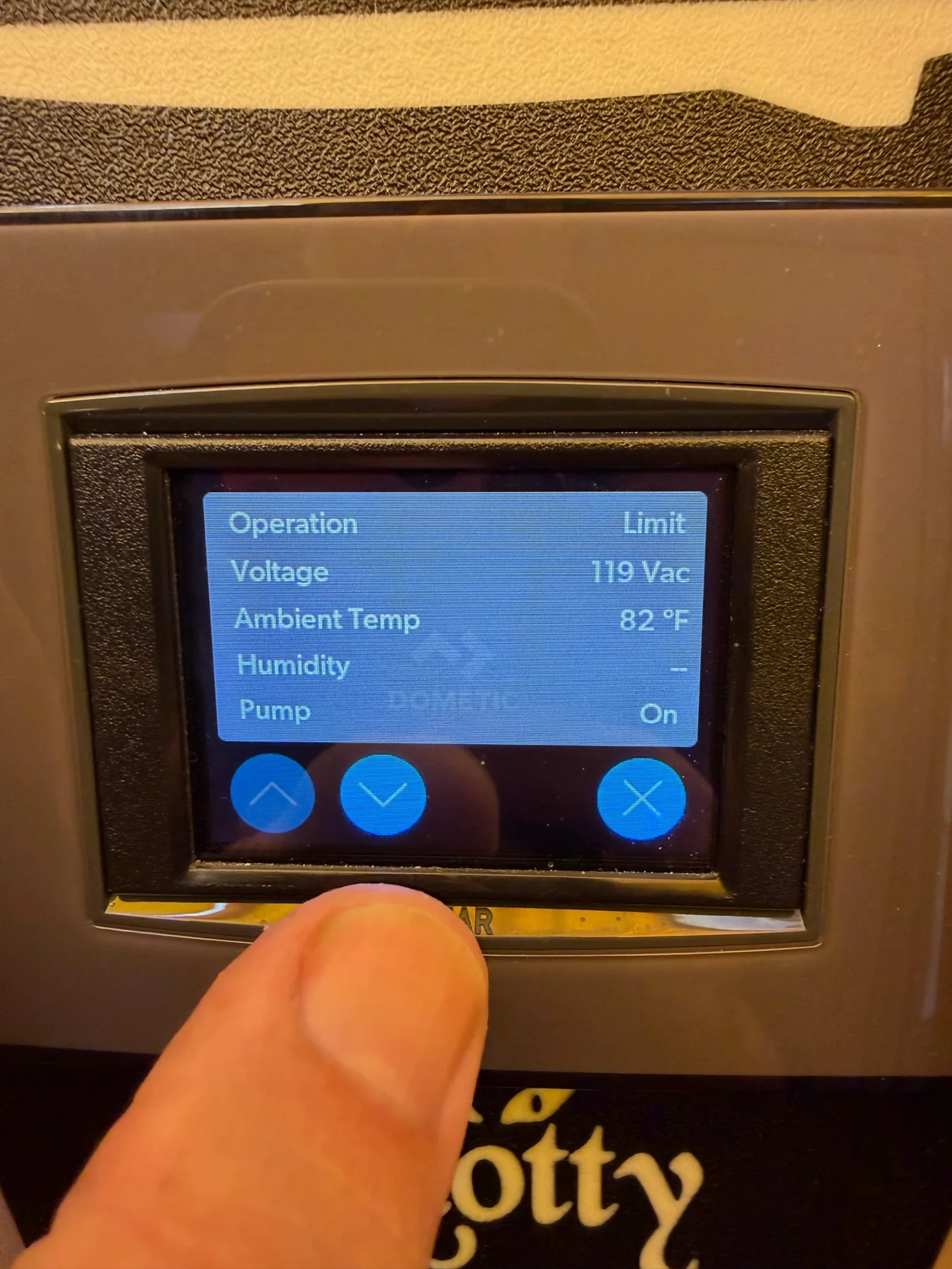 Installed marine digital control display showing voltage, temperature, and pump status