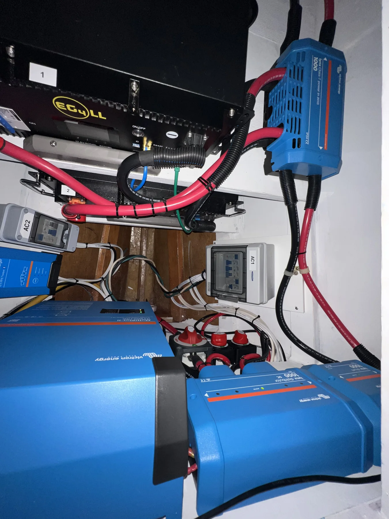 Marine power equipment with routed heavy red and black DC conductors.
