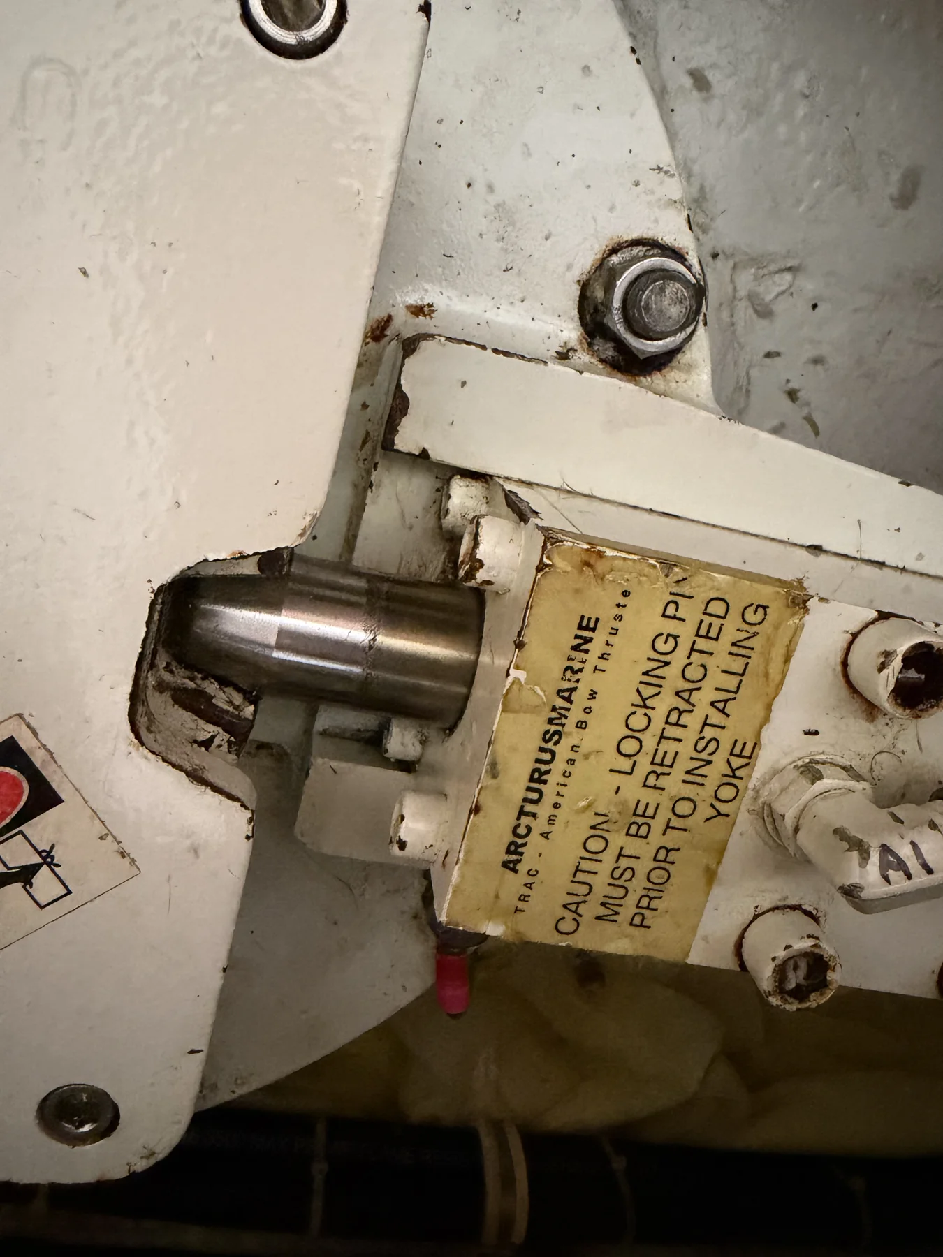 Close view of fin-stabilizer hardware and a manufacturer caution plate.