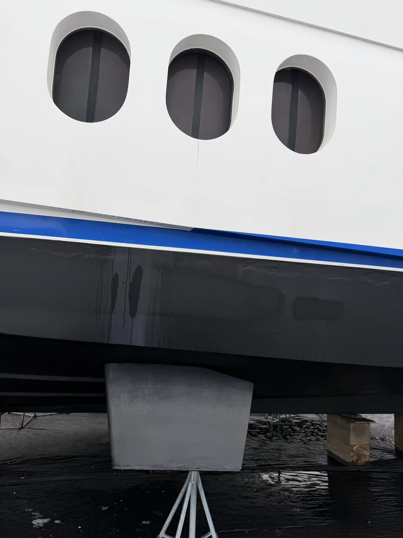 Stabilizer fin extending beneath the hull of a hauled motor yacht.