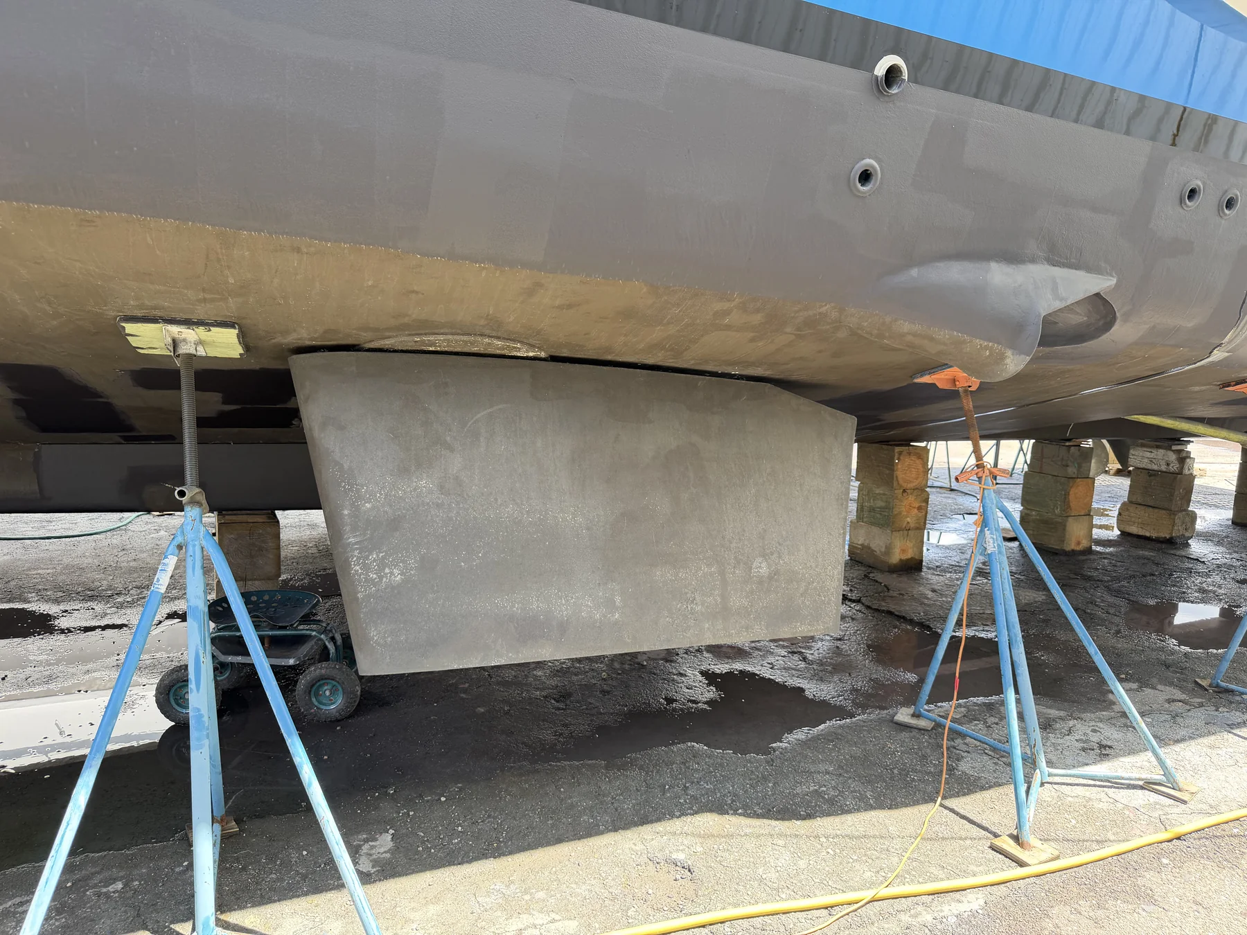Fin stabilizer visible below the hull of a large hauled yacht.