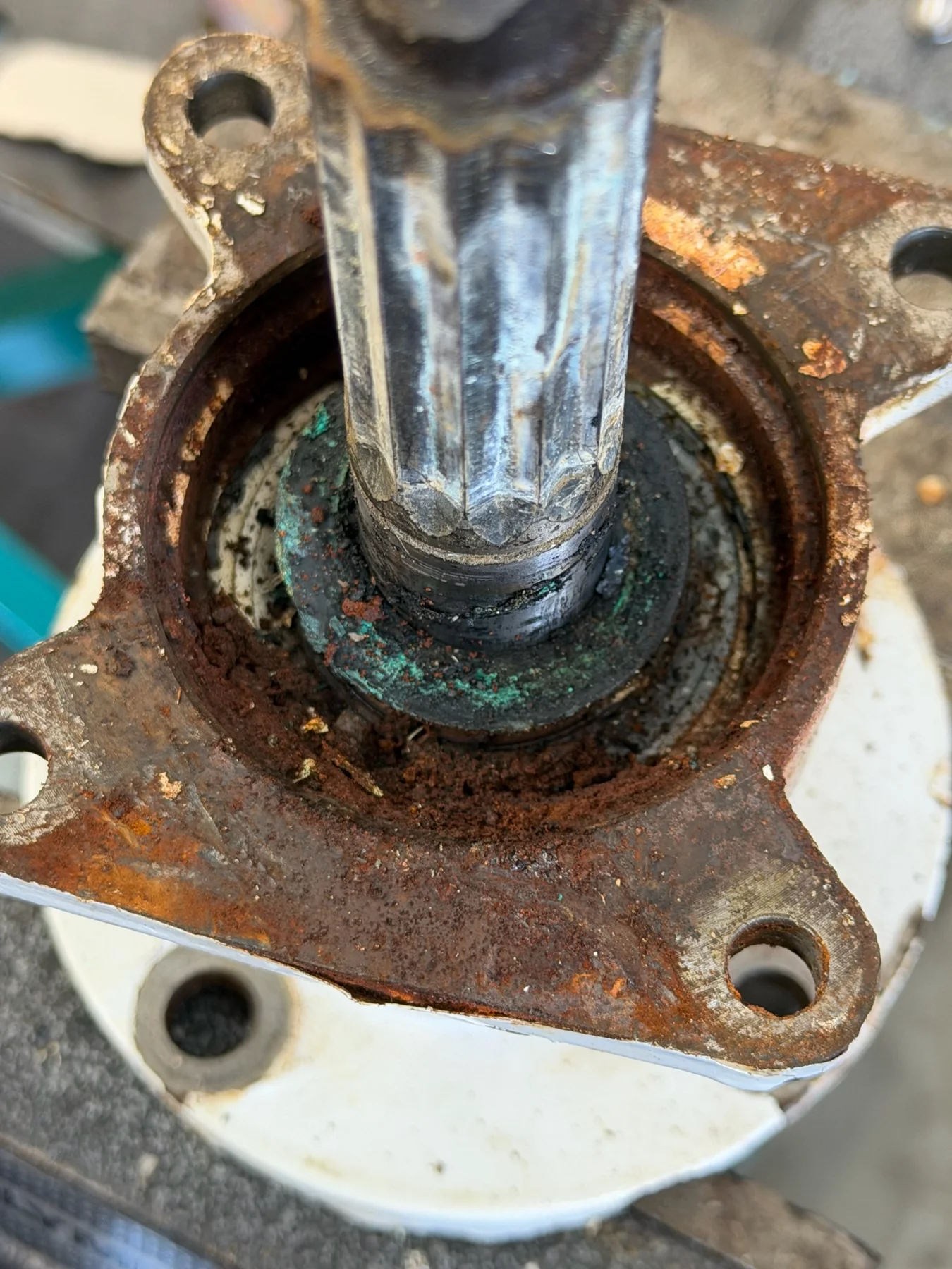 Disassembled splined marine shaft and housing with corrosion around the seal area