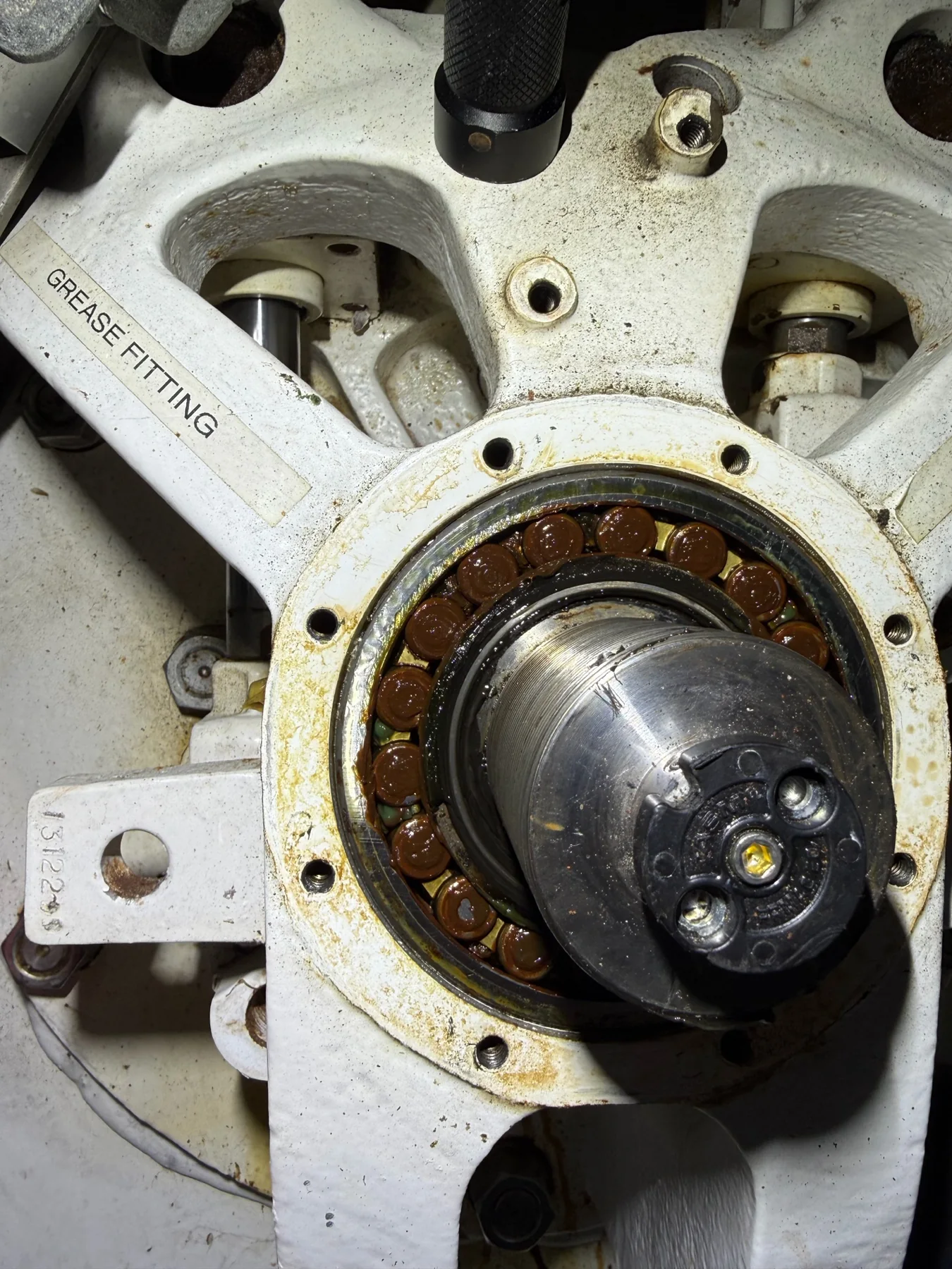 Exposed marine stabilizer fin-shaft bearing with visible corrosion and wear