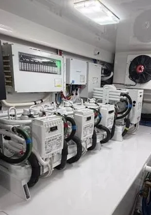 Marine chiller machinery and connected hoses inside an equipment room