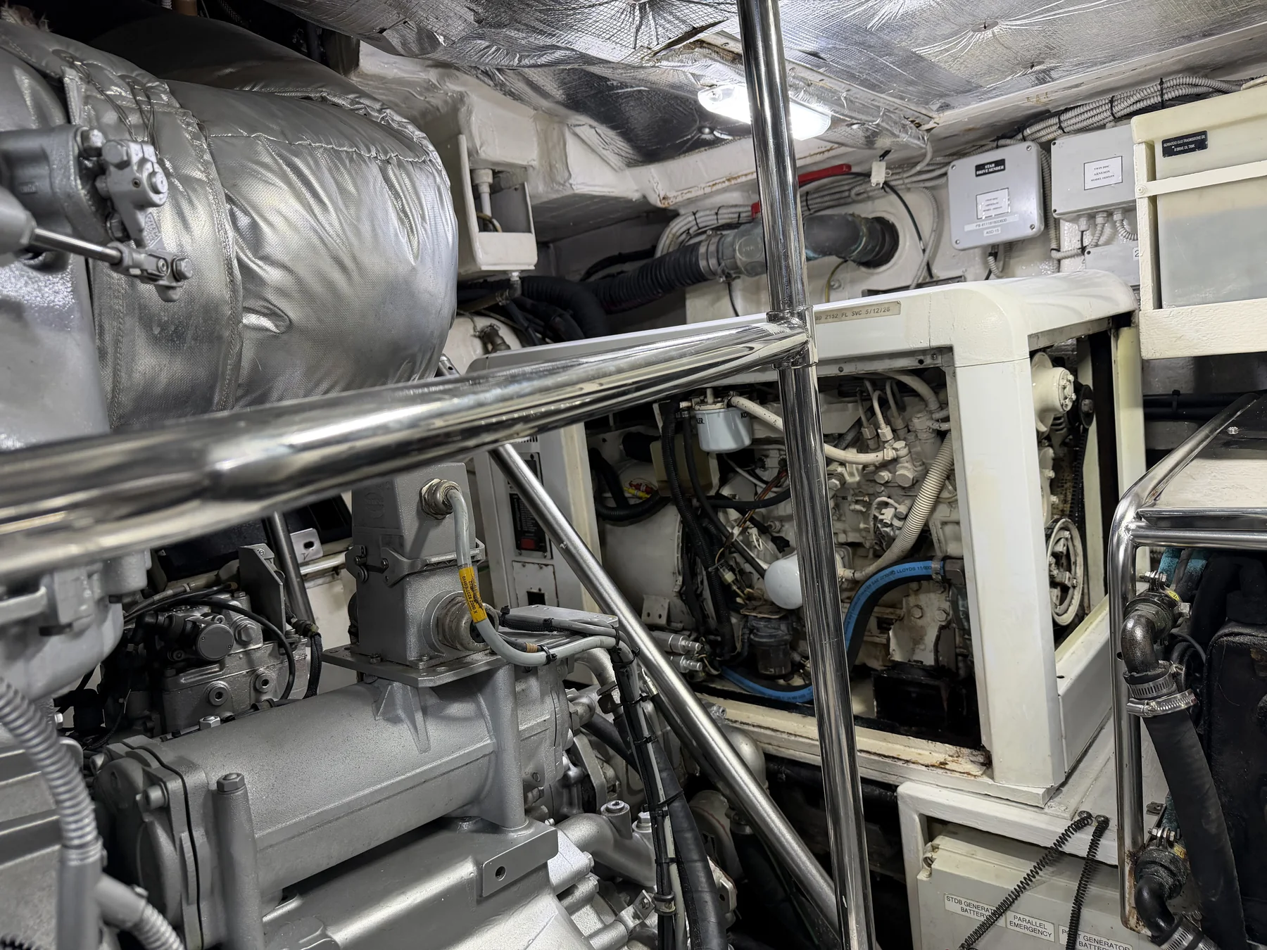 Cummins Onan generator and surrounding machinery in the Pershing yacht engine room.