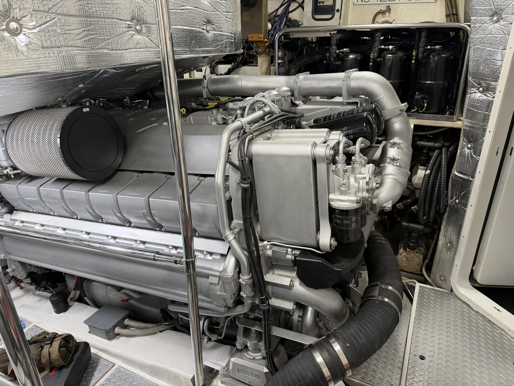 MTU engine in a yacht engine room with cooling and filtration components.