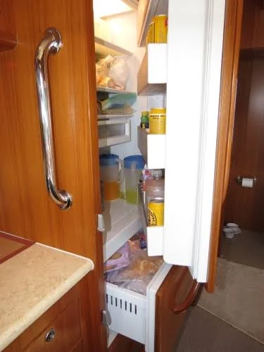 Refrigerator integrated behind finished yacht cabinetry