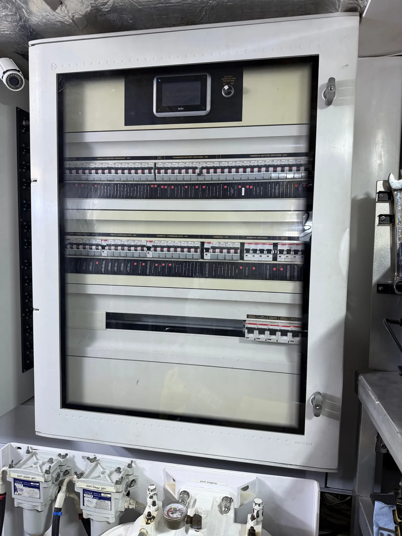 Marine main electrical distribution cabinet with rows of labeled breakers.