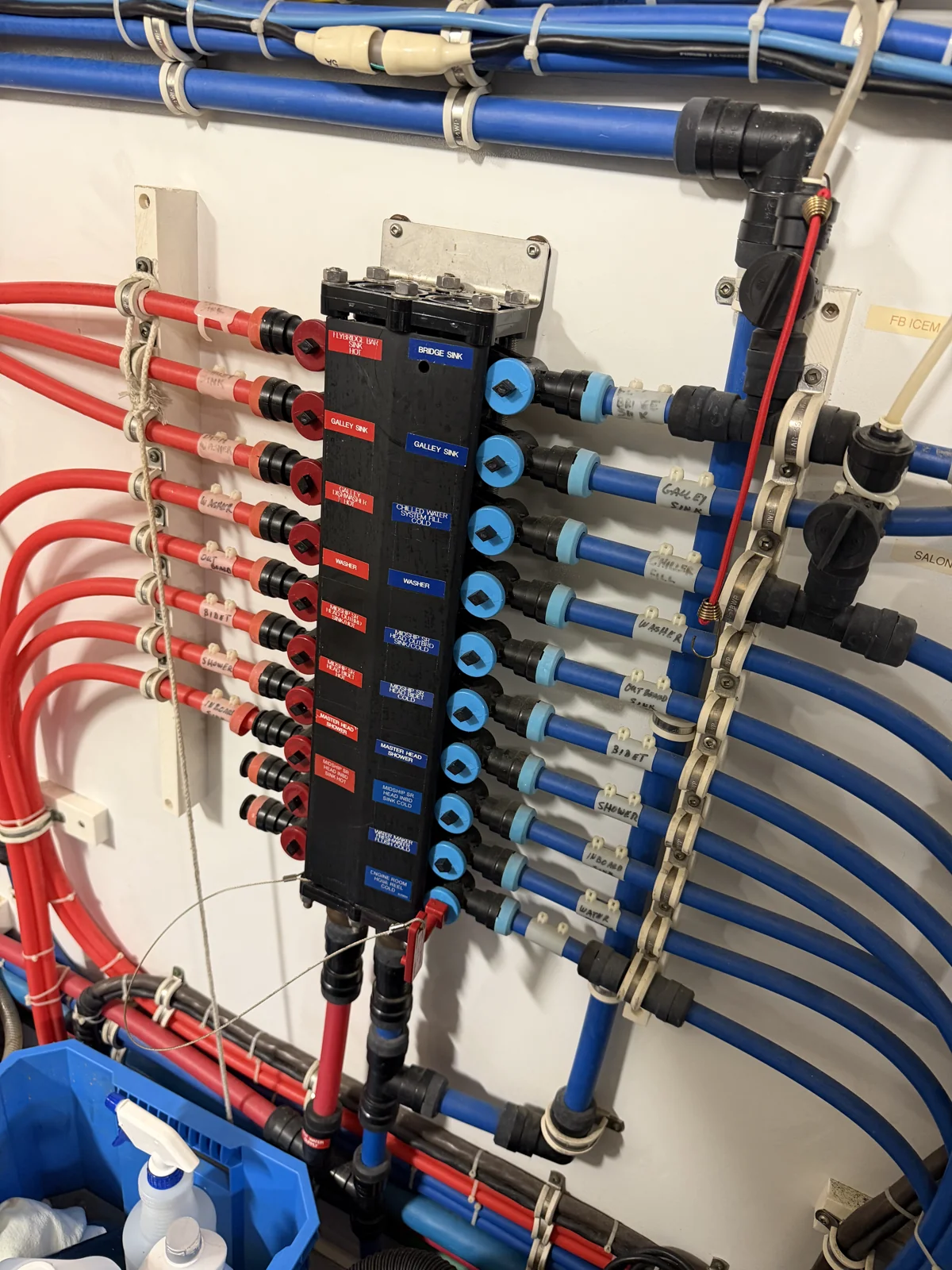 Water distribution block during service, with individual hot and cold branches and labeled piping.
